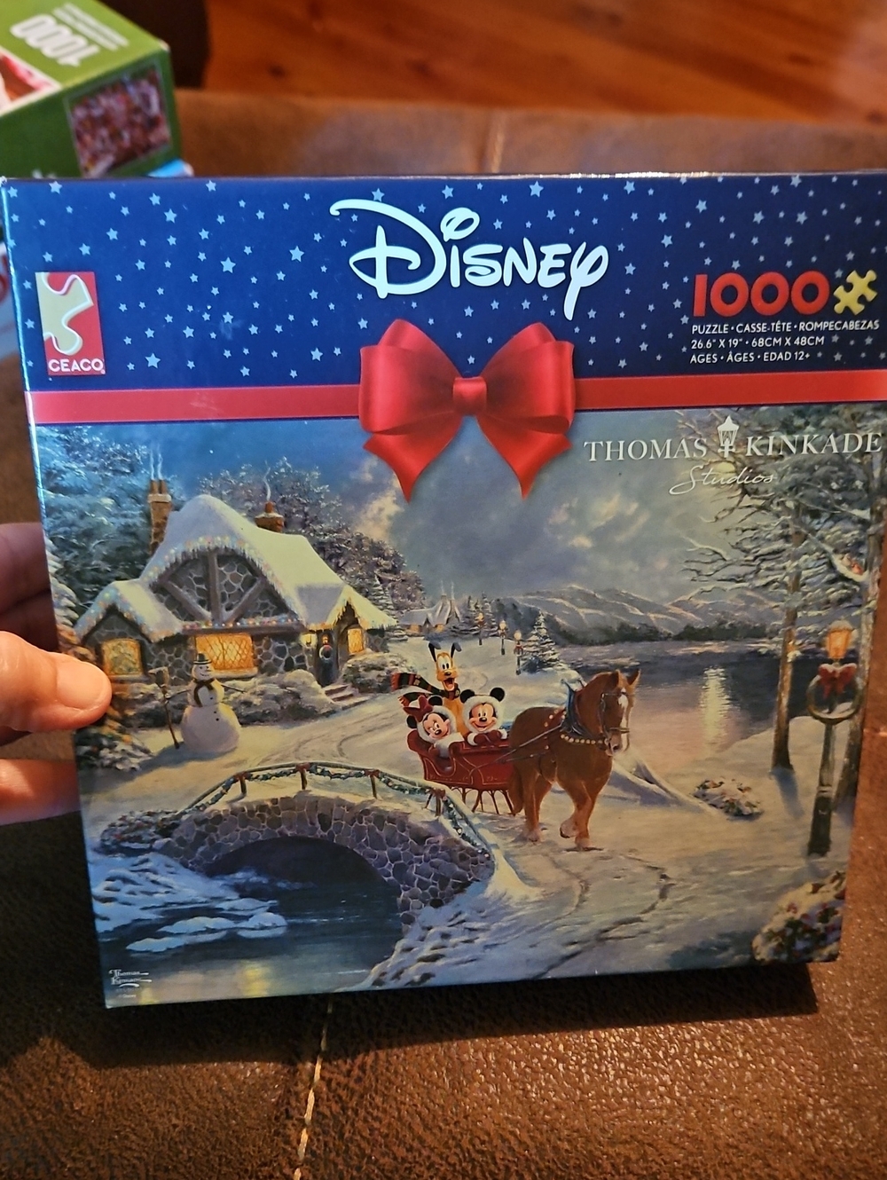 Disney Thomas Kinkade Holiday Puzzle with Red Bow and Snowy Blue Artwork